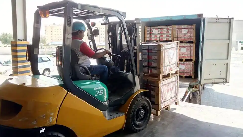 Picture of loading cargo in the truck using a forklift for a shipping company in dubai